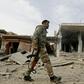 A fighter from the Syrian Democratic Forces (SDF) walks through the Syrian town of Hajin after it was recaptured from the Islamic State group