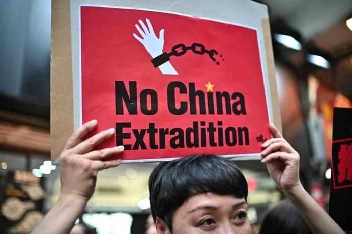 An activist holds a placard during a protest in Hong Kong on April 28, 2019 against a controversial move by the government to allow extraditions to the Chinese mainland