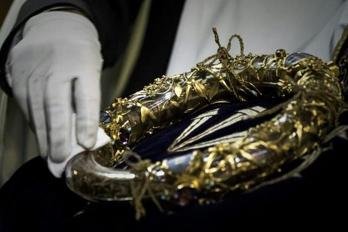 A priest seen wiping the Crown of Thorns, a relic believers say is from the crucifixion of Christ, and one of the most famous items saved at Notre-Dame A colossal fire swept through the famed Notre-Dame Cathedral in central Paris on April 15, 2019, cau...