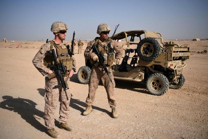 US Marines keep watch as unseen Afghan National Army soldiers participate in an IED (improvised explosive device) training exercise at Shorab Military Camp in Lashkar Gah, Afghanistan on August 28, 2017
