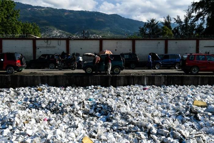 Plastic waste is seen floating on a sewage canal in the Haitian capital Port-au-Prince, on April 23, 2019. Around 180 governments Have agreed on a new UN accord to regulate the export of plastic waste
