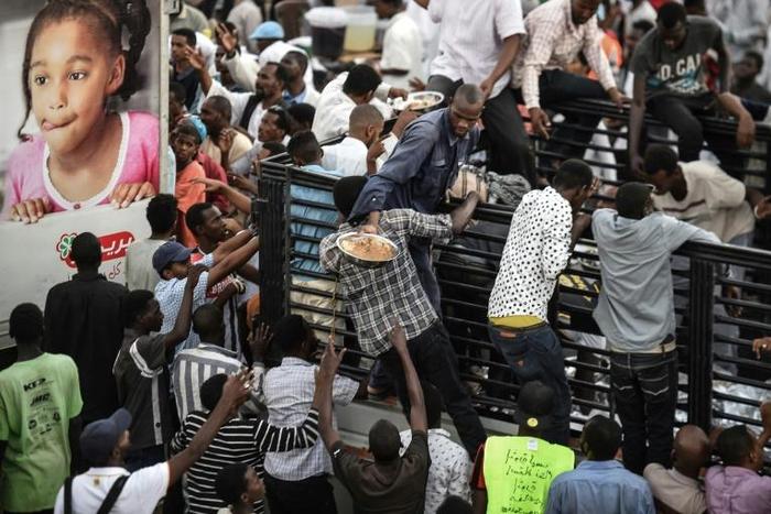 Sudanese protesters prepare to share an iftar meal as they break their fast on the first day of the Muslim holy month of Ramadan outside the army headquarters in Khartoum on May 6, 2019 Defiant Sudanese protesters broke their fast on the first day of R...