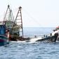 Indonesian authorities sink an impounded Vietnamese fishing boat at Datuk island,on May 4, 2019.