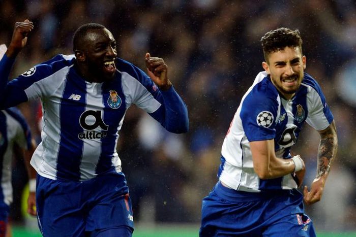 Porto's Brazilian defender Alex Telles (R) celebrates a goal with teammate Malian forward Moussa Marega during the UEFA Champions League round of 16 second leg football match between FC Porto and AS Roma at the Dragao stadium in Porto on March 6, 2019.