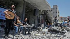 The Palestinian band Dawaween performs on May 14, 2019 on the rubble of a building in the Gaza Strip that was recently destroyed by Israeli air strikes during an event calling for a boycott of the Eurovision song contest hosted by Israel