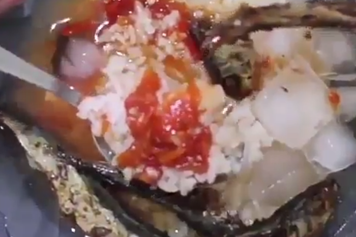 Rice, stew with fried fish and ice cubes