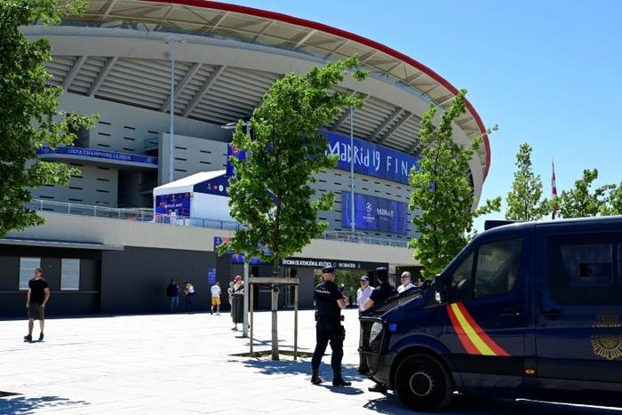 Spanish police officers stand guard outside the Wanda Metropolitan Stadium in Madrid ahead of the UEFA Champions League final football match between Liverpool and Tottenham Hotspur on Saturday