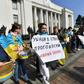 An activist holds a placard reading "Become part of the history - vote for the language law" during a rally in front of the Ukrainian parliament in Kiev on April 25, 2019