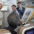 Pope Francis, shown here accepting a gift from an Arab journalist aboard the papal plane, said the problem of sexual abuse by priests could be found "anywhere"