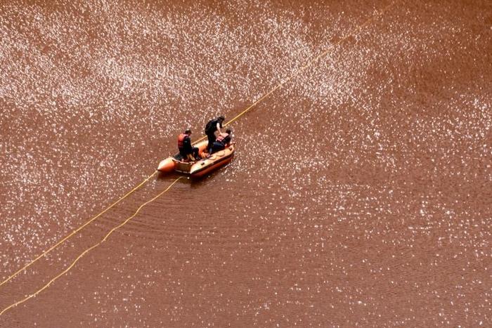 Cyprus forensic police officers probe the Red Lake out of the village of Mitsero, southwest of the capital Nicosia on April 30, 2019