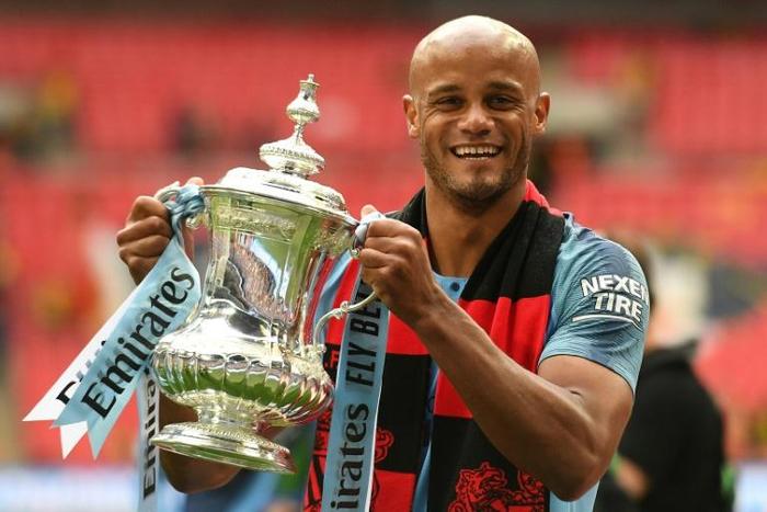 Manchester City's Belgian captain Vincent Kompany with the winner's trophy after the English FA Cup final football match between Manchester City and Watford at Wembley Stadium on Saturday