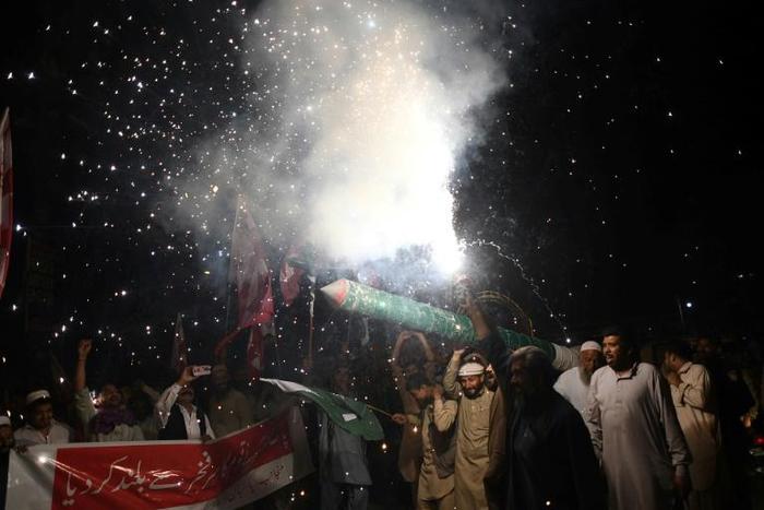 Pakistanis in Karachi celebrate the shooting down of two Indian fighter jets by the Pakistan Air Force