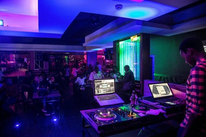 Young people enjoy the night life at the Fuschia Bar in Rwanda's capital Kigali. Many youths feel the absence of close kin they could never know, cut down in the three-month genocide