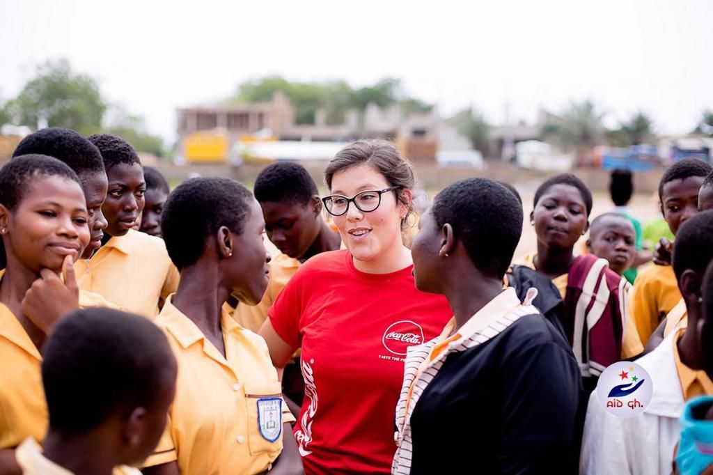 An Official of Coca-Cola chatting with some of the students
