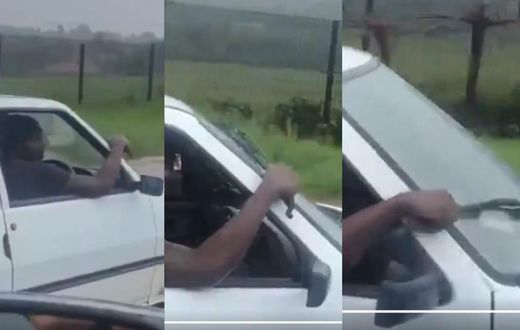 Rickety car driver uses his hand as manual wiper in heavy rain (Video)