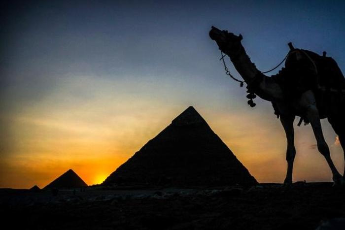 A camel walks past the pyramid of Khafre (also known as Chephren) at the Giza pyramids necropolis on the southwestern outskirts of the Egyptian capital Cairo
