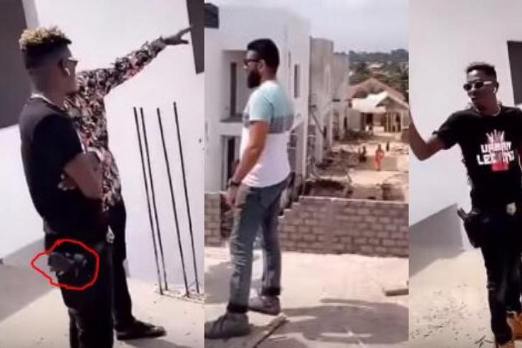 Shatta Wale strapped with a gun while inspecting his Kumasi mansion
