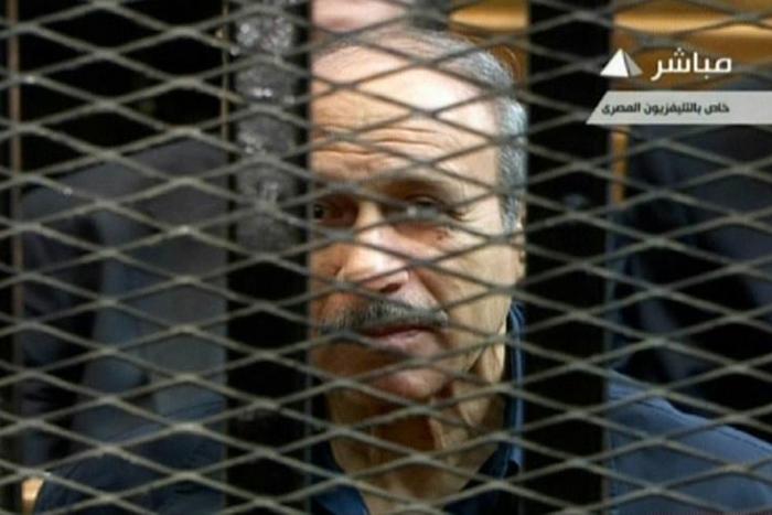 Former Egyptian interior minister Habib al-Adly is seen behind bars during a trial in Cairo in 2013, in an image grab from state TV
