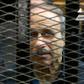 Former Egyptian interior minister Habib al-Adly is seen behind bars during a trial in Cairo in 2013, in an image grab from state TV