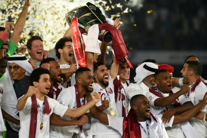 Qatar's players celebrate with the trophy after winning the 2019 AFC Asian Cup final football match between Japan and Qatar at the Zayed Sports City Stadium in Abu Dhabi on February 1, 2019