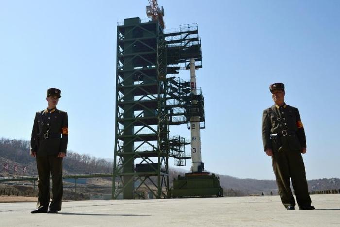 Soldiers stand guard in front of the Unha-3 rocket at North Korea's Sohae Satellite Launch Station, in 2012