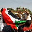 Sudanese protesters wave their national flag and chant slogans during an anti-government demonstration in the capital Khartoum's twin city of Omdurman on January 31