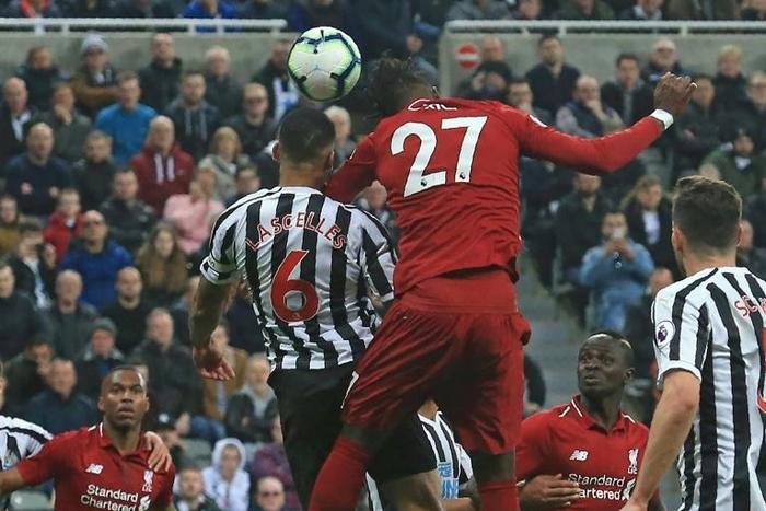 Divock Origi heads the winner against Newcastle to lift Liverpool back to the top of the Premier League