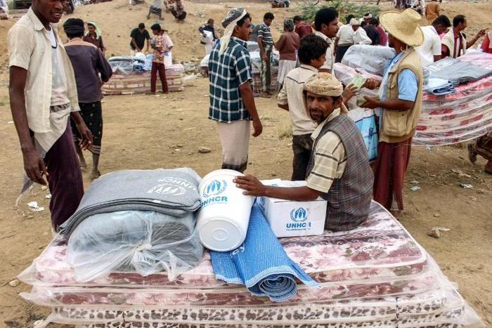 Yemenis displaced from areas near the border with Saudi Arabia receive humanitarian aid given by the Norwegian Refugee Council (NRC) and the UN High Commissioner for Refugees (UNHCR) in the northern province of Hajjah on March 11, 2019