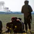 Smoke billows as fighters with the US-backed Syrian Democratic Forces keep watch in the Baghouz area in eastern Syria on February 12, 2019 during an operation to expel hundreds of Islamic State group jihadists from the region