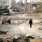 A fighter in a US-backed alliance battling the Islamic State group in eastern Syria walks near the village of Baghouz on January 27, 2019