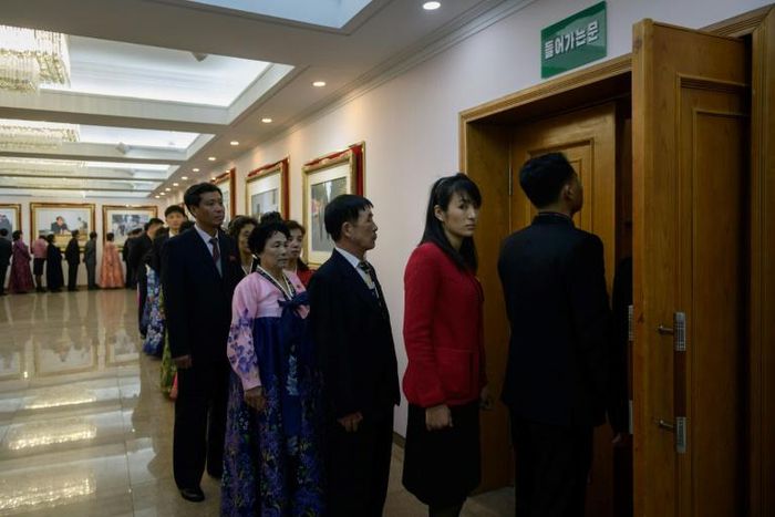 Voters queue to cast their ballots at the '3.26 Pyongyang Cable Factory' during voting for the Supreme People's Assembly elections in Pyongyang