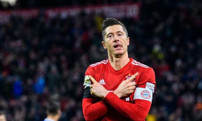 Robert Lewandowski celebrates scoring his 100th goal at the Allianz Arena in Bayern colours