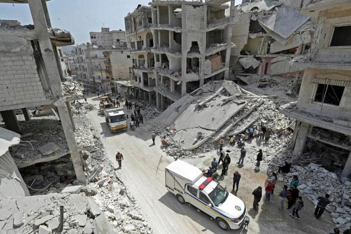 Members of the Syrian Civil Defence, also known as the "White Helmets", search the rubble of a collapsed building following an explosion in the town of Jisr al-Shughur, in the mostly rebel-held Syrian province of Idlib, on April 24, 2019