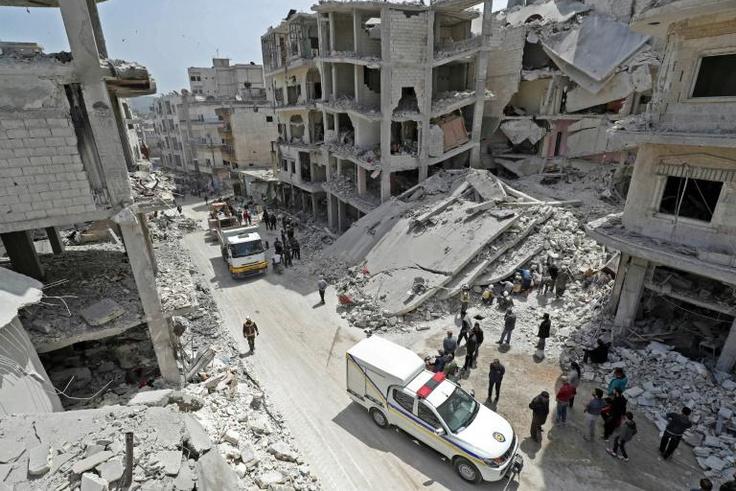 Members of the Syrian Civil Defence, also known as the "White Helmets", search the rubble of a collapsed building following an explosion in the town of Jisr al-Shughur, in the mostly rebel-held Syrian province of Idlib, on April 24, 2019