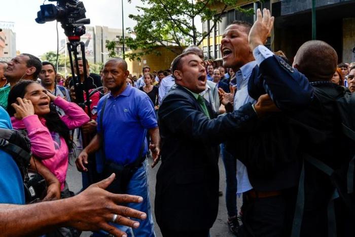 Opposition lawmaker Gilber Caro, pictured in 2016 (second from right), was arrested in a restaurant in the Las Mercedes neighborhood of the capital Caracas