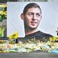 Mourners left yellow flowers below the portrait of Argentine football forward Emiliano Sala at the Beauvoir stadium in Nantes following his death in January 2019