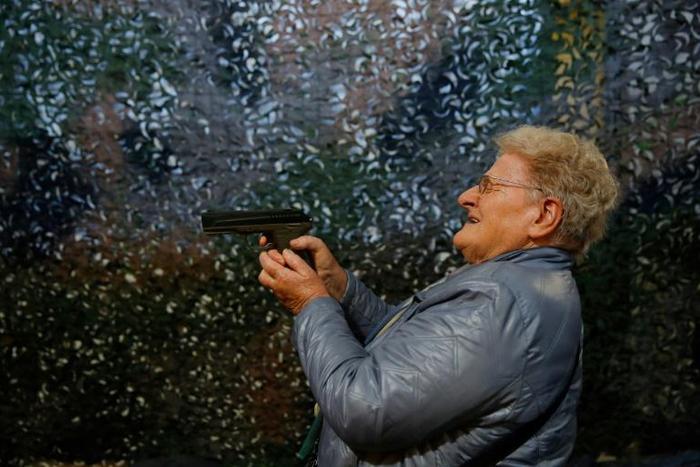 A visitor tries out a CO2 air pistol during a recent Arms Trade Fair in Lucerne, ahead of the Swiss vote on whether to toughen the country's gun laws