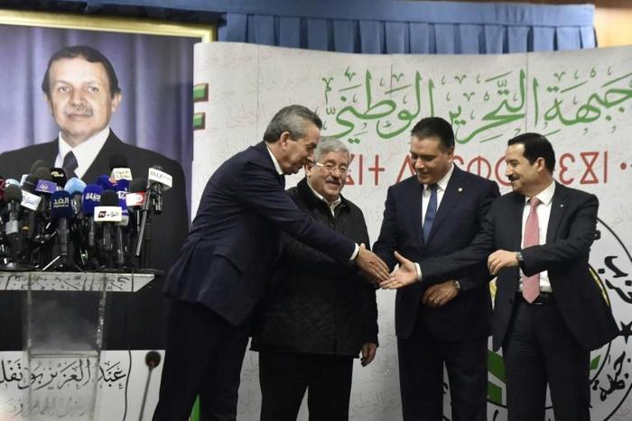 Algeria's ruling coalition principals -- (L to R) Amara Benyounes, Ahmed Ouyahia, Mouad Bouchareb, and Amar Ghoul -- shake hands after agreeing to back President Abdelaziz Bouteflika for a fifth term in Algiers on February 2, 2019