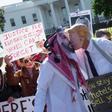 Demonstrators dressed as Saudi Crown Prince Mohammed bin Salman and US President Donald Trump pretend to kiss in a demonstration outside the White House in October 2018