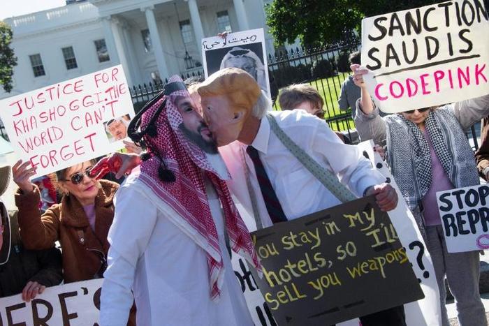 Demonstrators dressed as Saudi Crown Prince Mohammed bin Salman and US President Donald Trump pretend to kiss in a demonstration outside the White House in October 2018