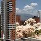 A cloud of smoke rises up from the ground following the demolition of the late drug baron Pablo Escobar's Medellin fortress