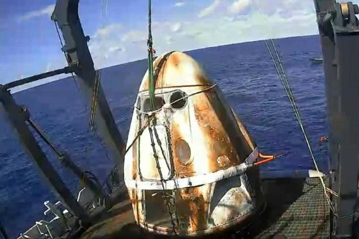 This still image taken from NASA TV shows SpaceX's Crew Dragon spacecraft safely aboard the company's recovery vessel following splashdown on March 8, 2019