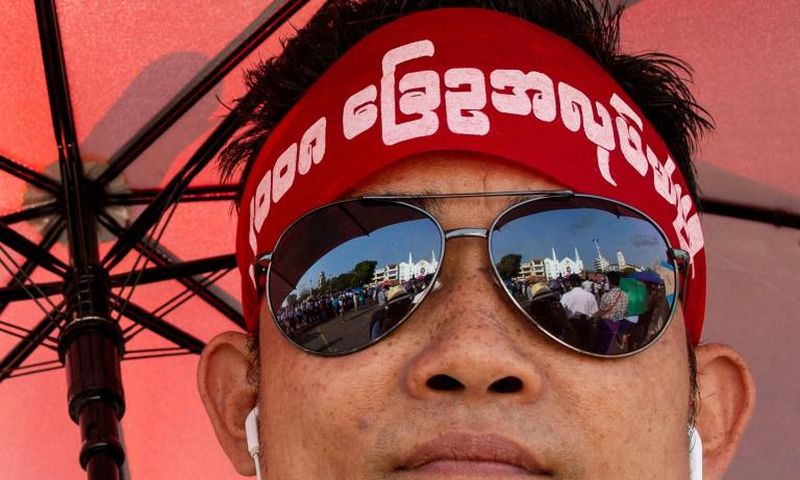 The rally drew hundreds wearing headbands and T-shirts calling for reform of the military-scripted constitution