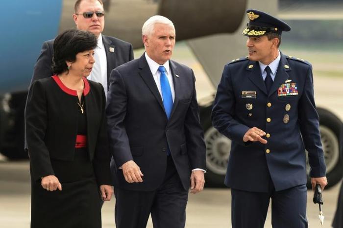 US Vice President Mike Pence (C) is welcomed by Colombia's Foreign Affairs Vice Minister Luz Stella Jara (L) and Colombia's Air Force General Luis Carlos Cordoba, upon arrival in Bogota, on February 25, 2019