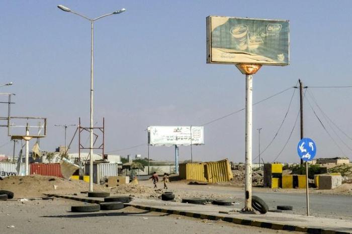 Members of the Yemeni pro-government forces (pictured November 2018) walk through destruction in an industrial district in the eastern outskirts of the port city of Hodeida, where Huthi rebels will begin a pullback