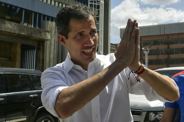 Venezuelan opposition leader and self declared acting president Juan Guaido gestures to supporters at the end of a rally with volunteers