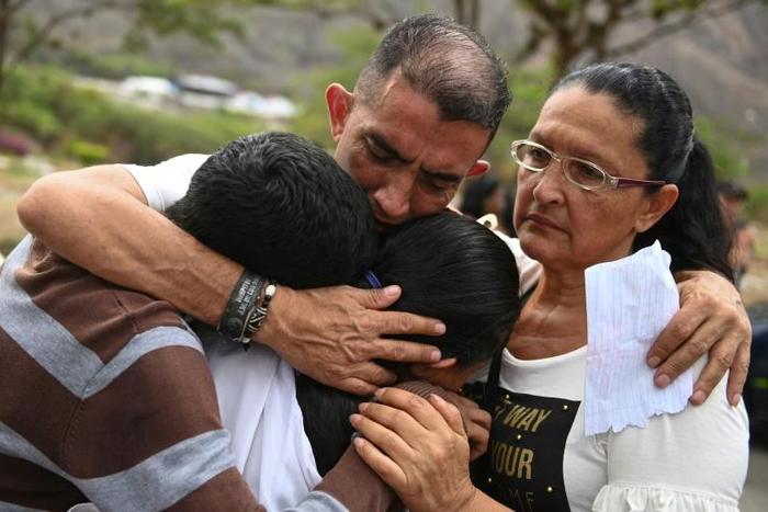 Gilberto Altuve (C), father of 11-year-old boy Erick Altuve, who died of cancer while waiting for a bone marrow transplant in Venezuela, mourns during his funeral