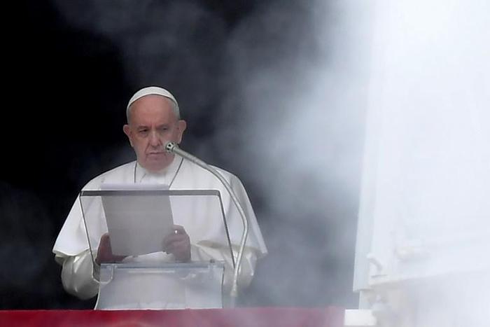 Pope Francis stands at the window of the Apostolic Palace overlooking St Peter's square in the Vatican