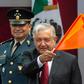 Mexican President Andres Manuel Lopez Obrador waves an orange flag as he declares work officially under way to turn the Santa Lucia military air base into a second airport for the sprawling capital