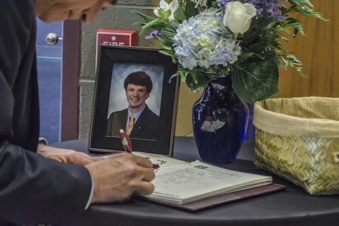 A mourner signs a guest book in June 2017 during the funeral for Otto Warmbier, who was imprisoned after being accused of taking down a propaganda poster in his hotel during a tour trip to North Korea